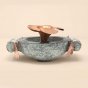 Handcrafted stone uruli with copper flower in the centre.