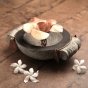 Handcrafted stone uruli with copper flower in the centre.